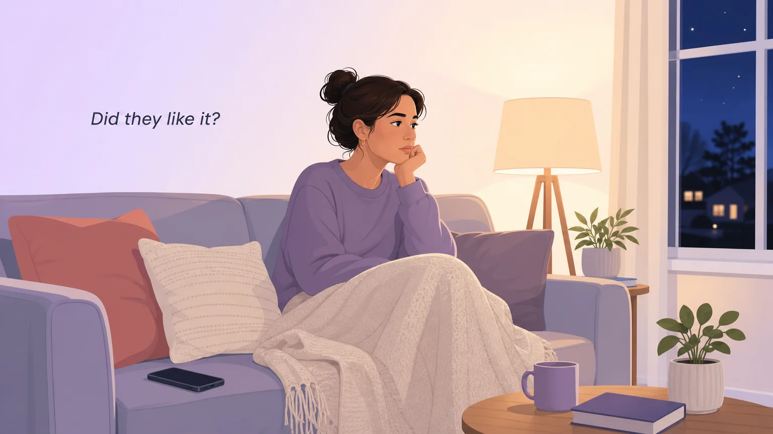 A woman sitting alone on a sofa at night under a blanket with her phone face down beside her, staring ahead, with the thought "Did they like it?" above her